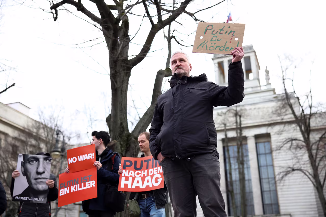 People hold placards as they gather in front of the Russian embassy in Berlin, Germany, on February 16.