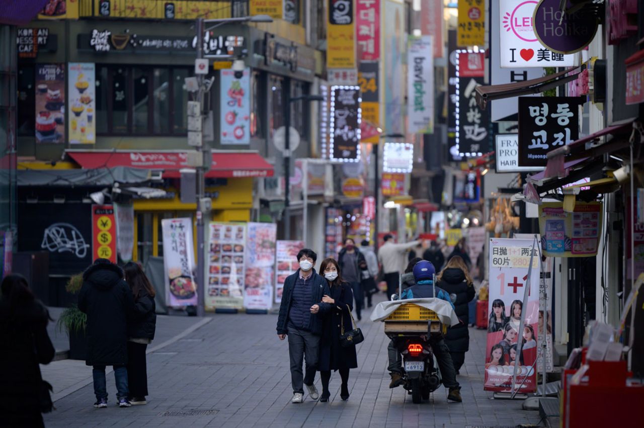 Shoppers walk along a street in the Myeongdong district of Seoul, South Korea on December 28.