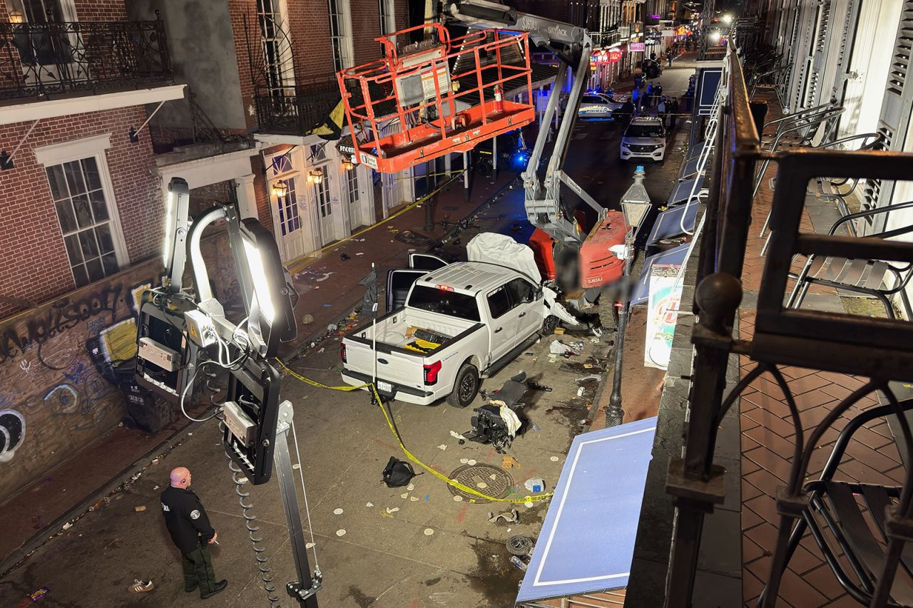 This picture taken from a balcony of the Royal Sonesta New Orleans hotel shows law enforcement gathering around the suspect pickup truck. The image has been blurred by CNN.