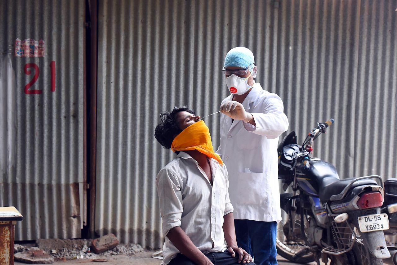 A health worker takes a swab sample from a man for coronavirus testing on September 6, in New Delhi, India. 