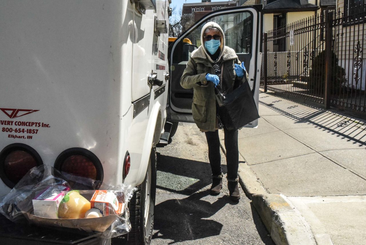 A person from Queens Community House delivers a meal to an elderly client in the Elmhurst neighborhood of New York City, on April 1.