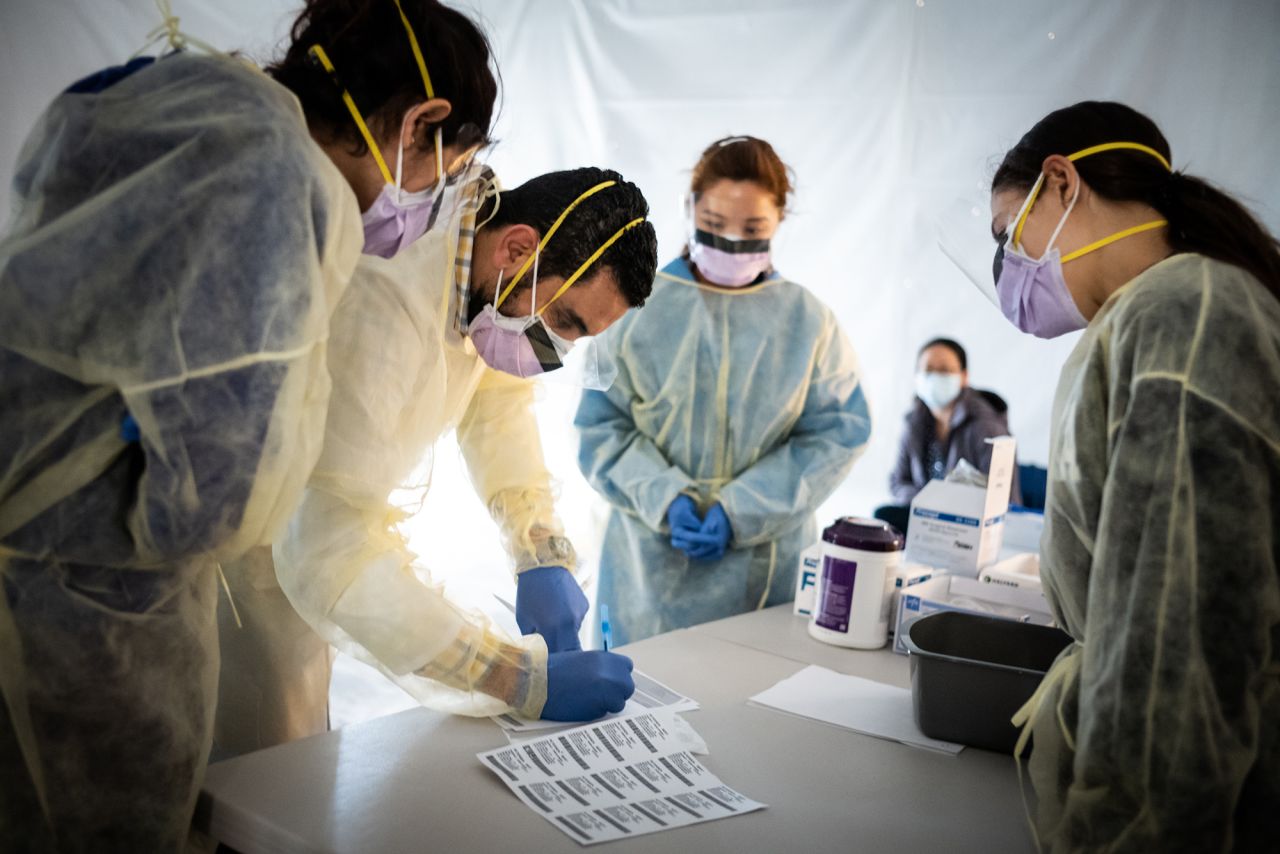 Doctors test hospital staff with flu-like symptoms for coronavirus before they enter St. Barnabas hospital in the Bronx, New York City on March 24. 