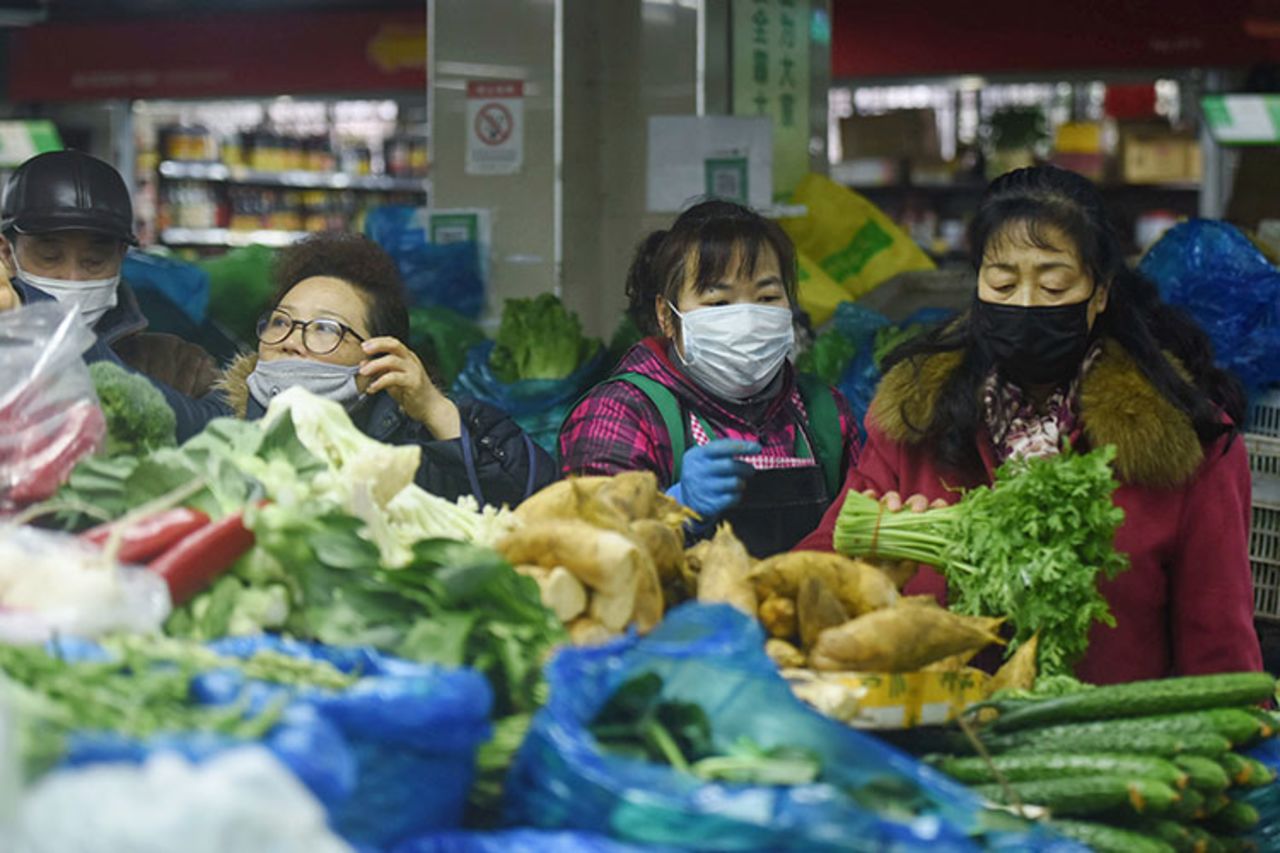 People buy vegetables in Hangzhou in China's eastern Zhejiang province on February 9.