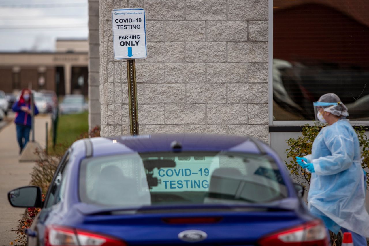 Registered nurse Erica Fairfield, right, works at the Hackley Community Care COVID-19 curbside testing site in Muskegon Heights, Michigan, on November 13.?