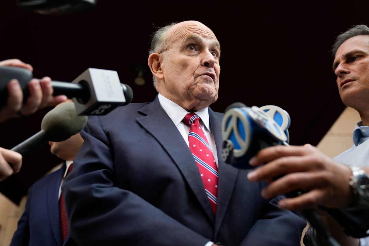 Rudy Giuliani speaks to reporters as he leaves his apartment building in New York on Wednesday before flying to Atlanta.