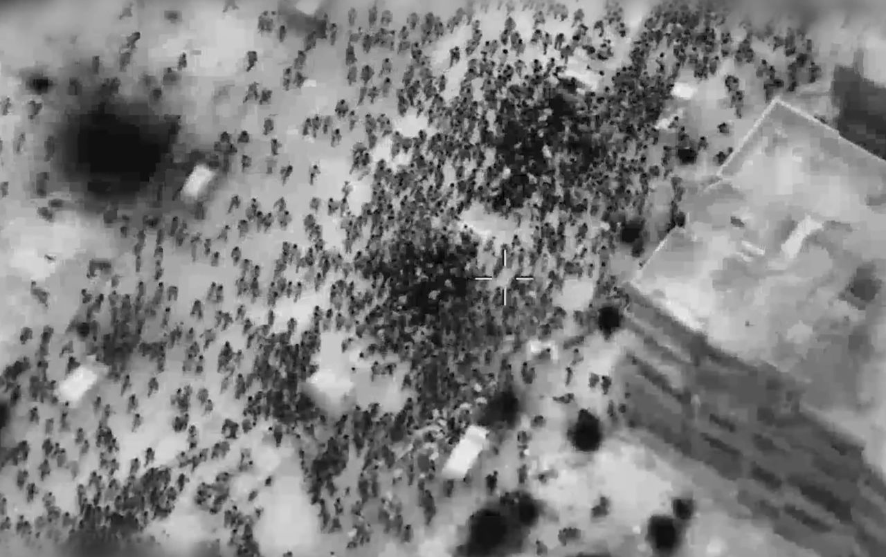 A screengrab captured from an IDF video shows Palestinians surrounding humanitarian aid trucks in Gaza City on Thursday.