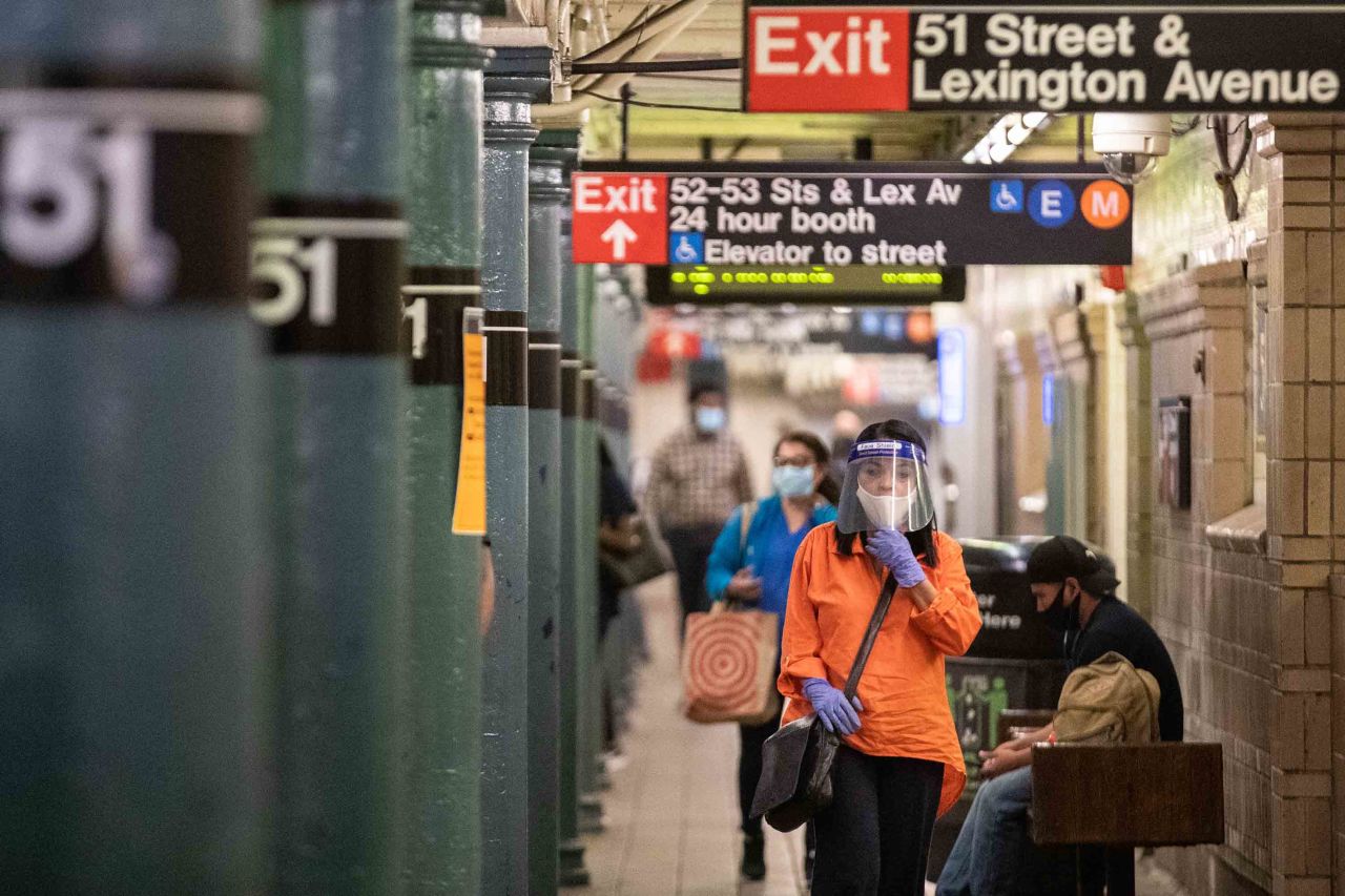 Commuters wearing protective masks on a New York subway station platform on June 22.