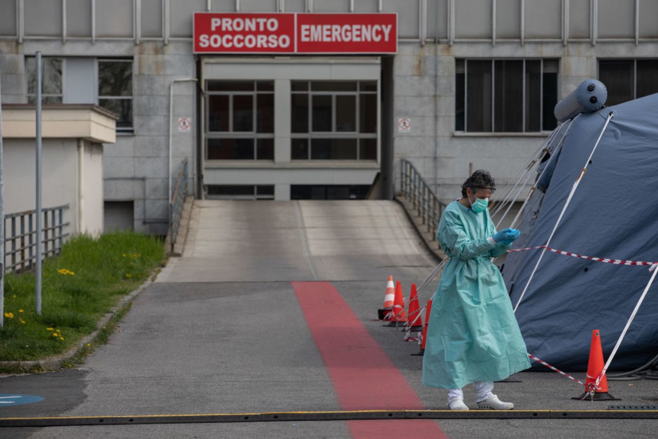 A nurse stands next to a pre-triage tent outside a hospital in Cremona, near Milan.