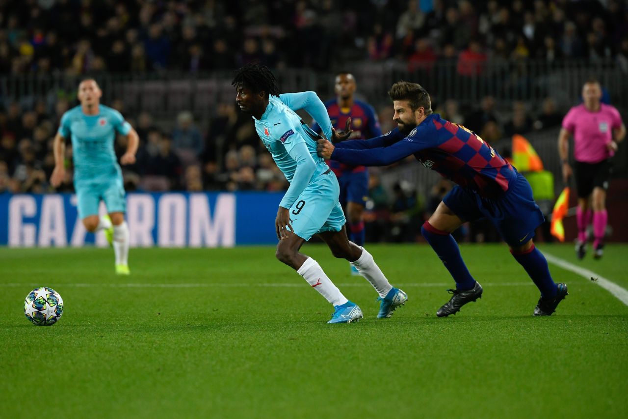 Gerard Pique attempts to wrestle Peter Olayinka to the ground after being beaten by the Slavia Prague forward.