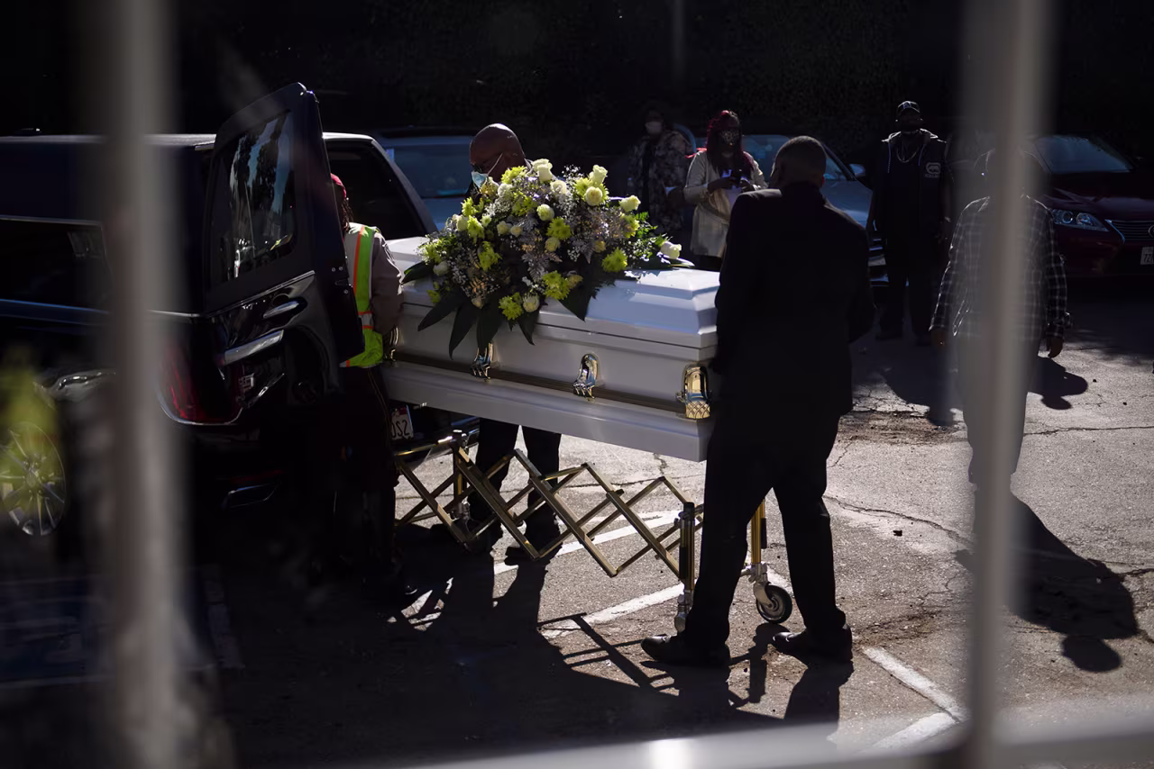 A casket is loaded into a hearse at the Boyd Funeral Home, as burials at cemeteries are delayed to the surge of Covid-19 deaths on January 14, in Los Angeles, California.