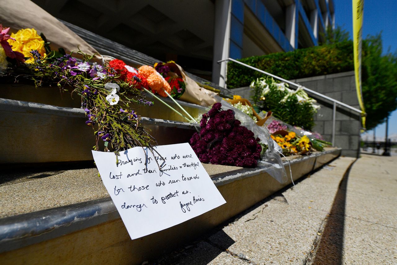 Flowers are placed on the steps of the Old National Bank in Louisville on April 11.