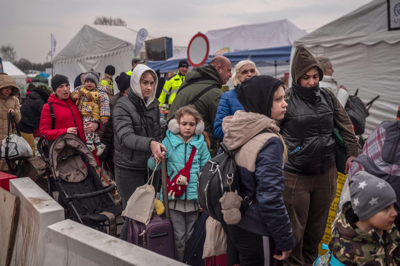 Ukrainian evacuees line up as they wait to cross the border at Medyka, Poland on March 29.