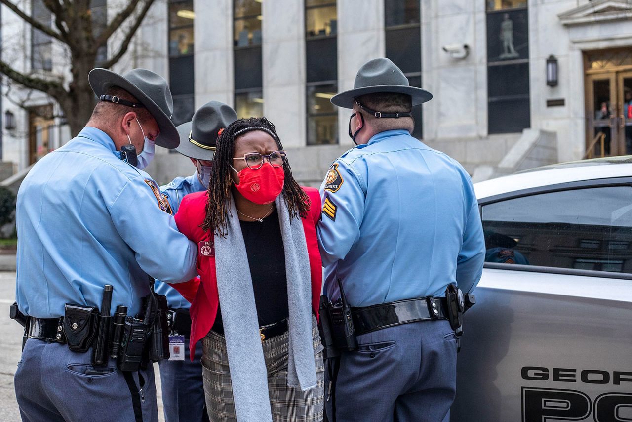 Georgia State Representative Park Cannon is placed into the back of a patrol car by Georgia state troopers after being arrested at the Georgia Capitol in Atlanta, on Thursday.