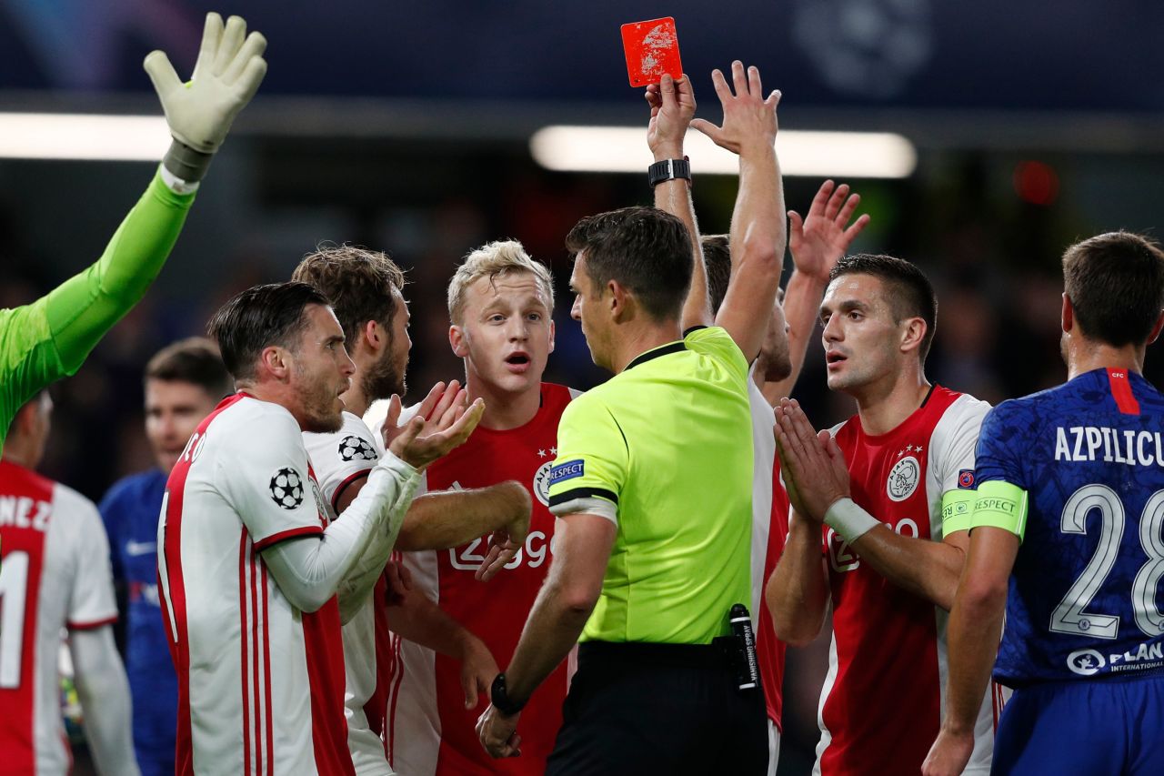 Ajax's players react after its defender Joel Veltman (C) is shown a red card by Italian referee Gianluca Rocchi.?