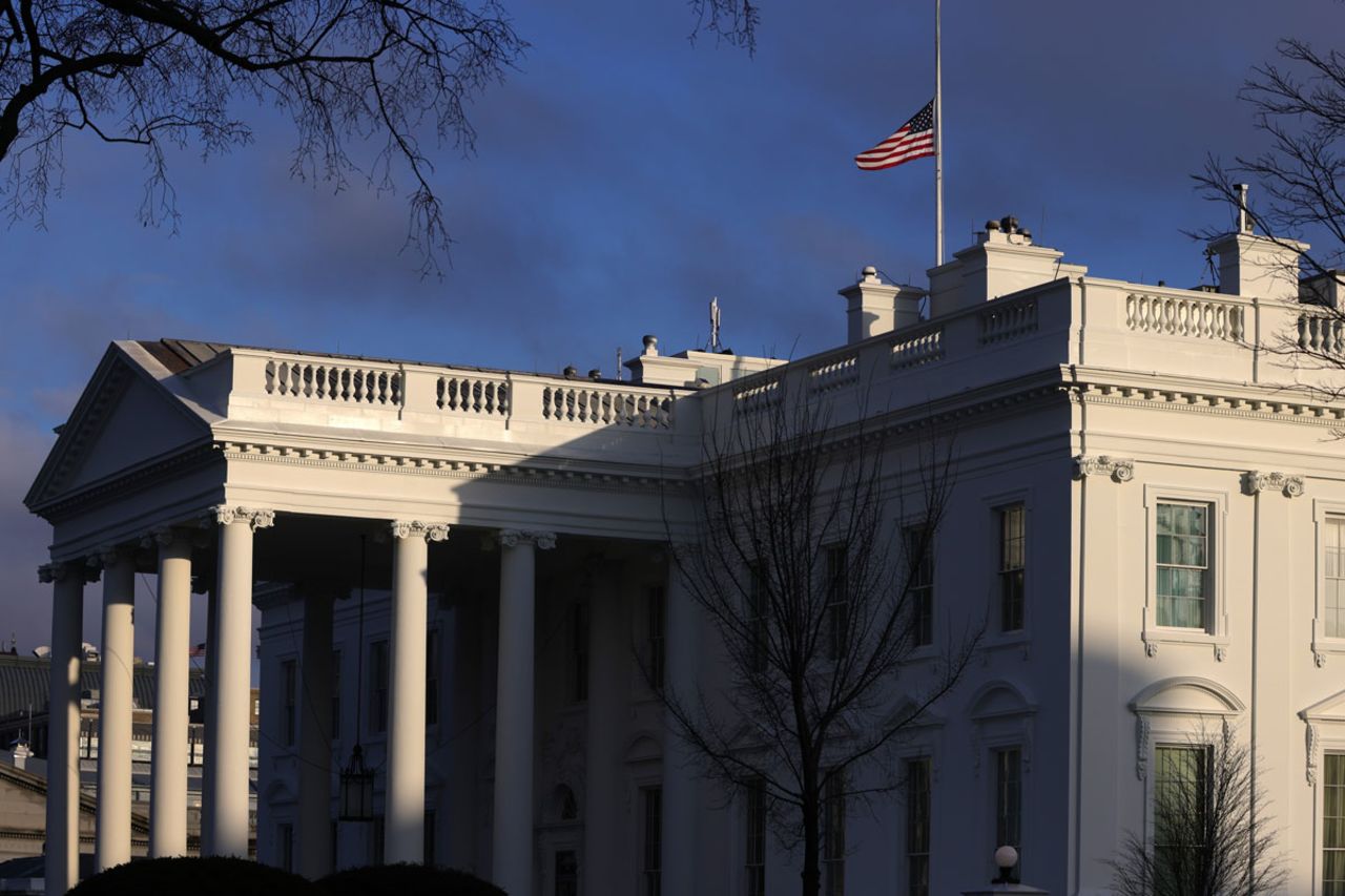 The U.S. flag is flied at half-staff on the roof of the White House to honor lives that have been lost to Covid-19 February 22 in Washington, DC.