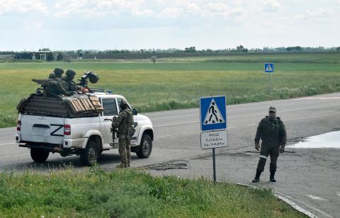 Russian servicemen are seen on a roadside in the Kherson region on May 19. 