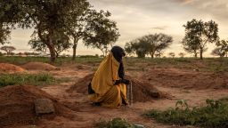 Khadija Ishag Abdullah mourns over the grave of her daughter, Naimat Ahmed, 10, who died from illness the day before in Adre, eastern Chad, August 6, 2024.