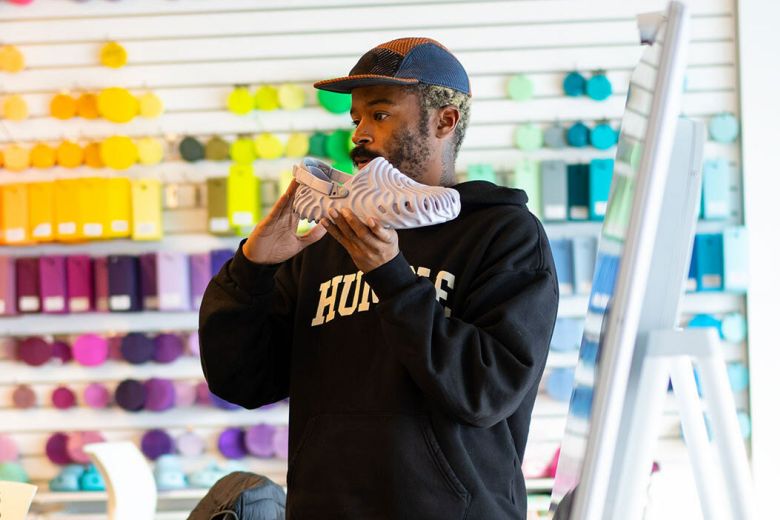 Bembury holding up a Crocs Pollex shoe.