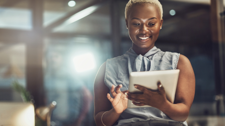 A woman uses a tablet.