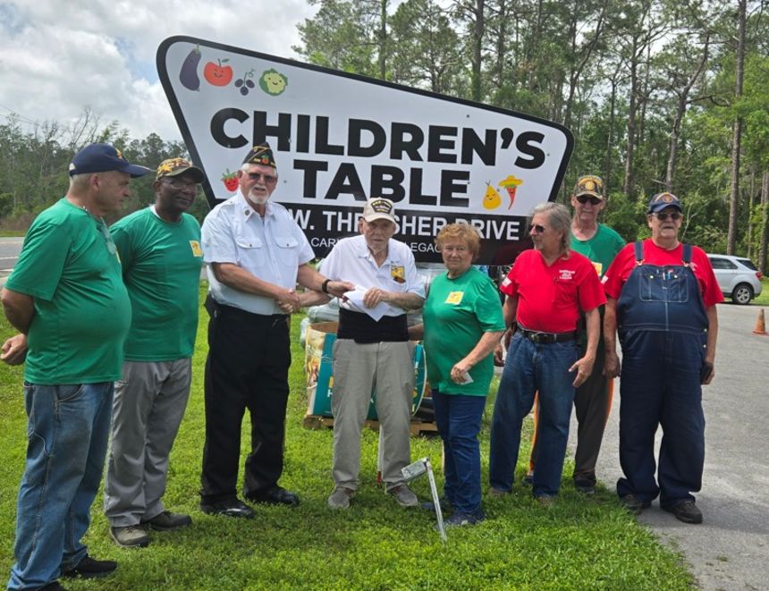 Bill and Verna Brown (center) outside the Children's Table headquarters in Bronson, FL.