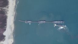 By March 20, satellite imagery from Maxar Technologies showed that the barges had moved about 15 km south along the coast. The images also captured a roll-on/roll-off (RO-RO) ferry docked beside the third and largest barge, positioned farthest from shore. Days later, a Planet Labs satellite image showed another RO-RO cargo ship approaching the same barge from the opposite side.