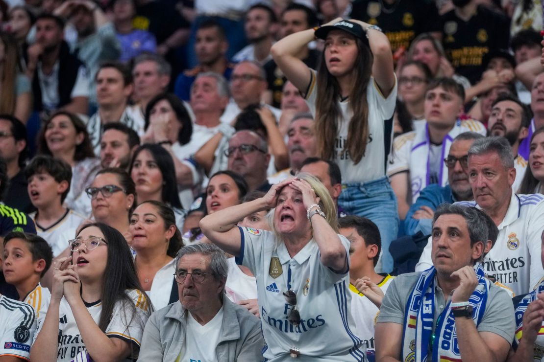 Real Madrid fans watch on nervously as the final plays out.