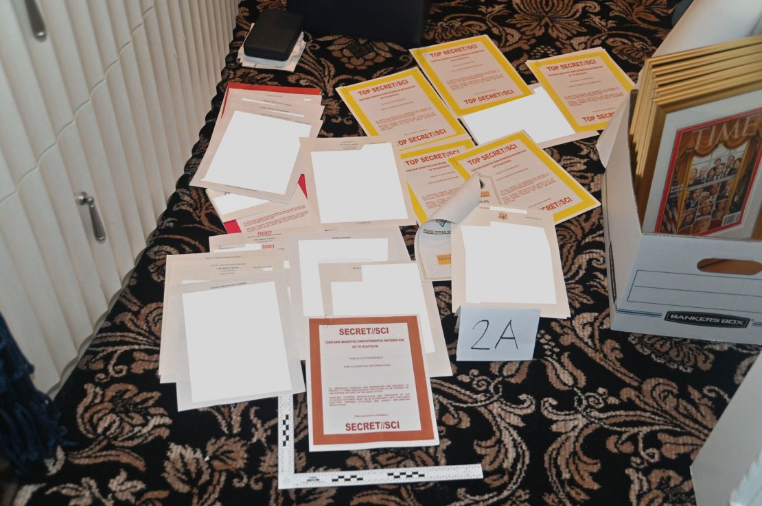 This photo from the U.S. Department of Justice shows classified intelligence documents found during the search at Mar-a-Lago. On the left is a filing chest made by Sligh Furniture. On the right, the cover of Time magazine from March 4, 2019.