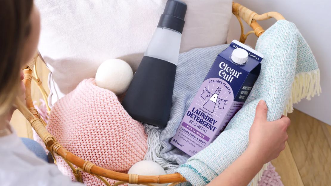 Person holding laundry basket with clean cult laundry detergent