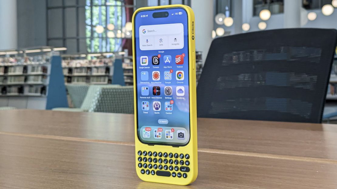 iPhone 15 Pro with a yellow Clicks keyboard case attached.