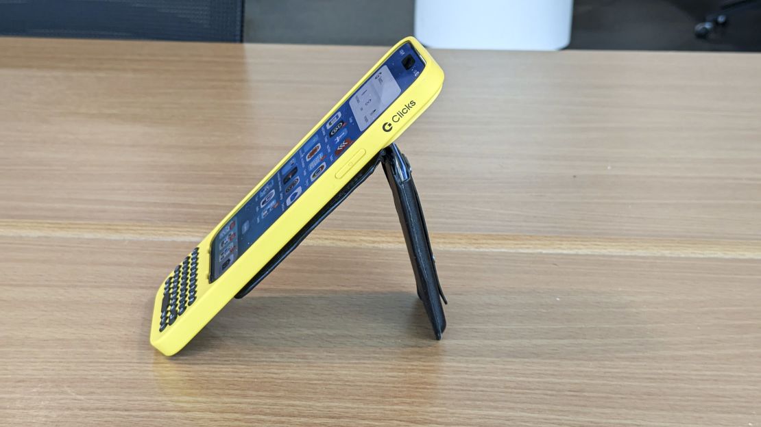 Side of the yellow Clicks keyboard case with MagSafe wallet attached to the back.