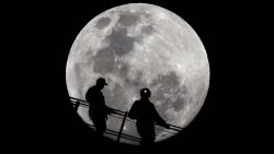 Climbers are silhouetted against the full moon as they descend from the summit of the Sydney Harbour Bridge on September 17, 2024. (Photo by Saeed KHAN  AFP) (Photo by SAEED KHANAFP via Getty .jpg