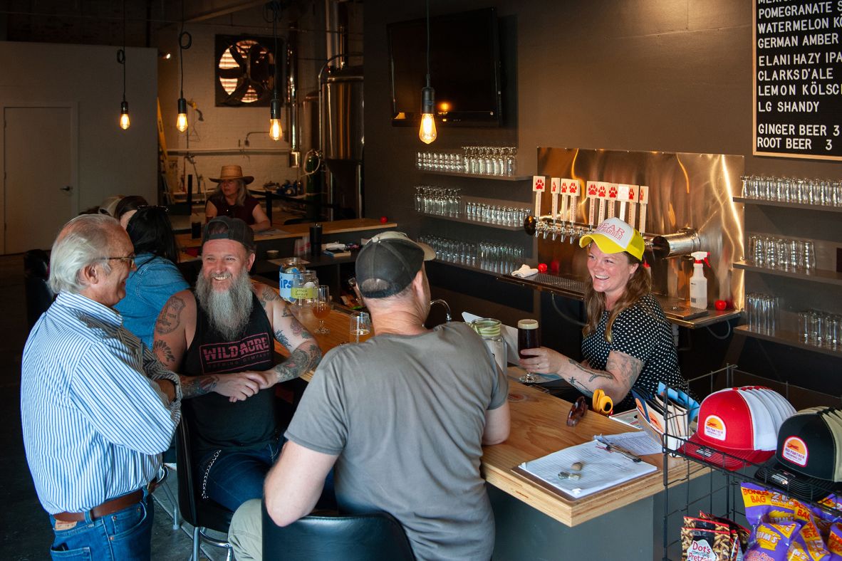 <strong>A local brew:</strong> Bartender Bear Ryan (right) serves beer at Red Panther Brewing Co. in June.