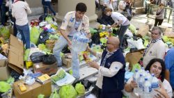 Volunteers load a truck with donated supplies in front of the Metropolitan Cathedral in Buenos Aires on Thursday, April 4. Rescuers were still searching for people missing in nearby La Plata after the storm.