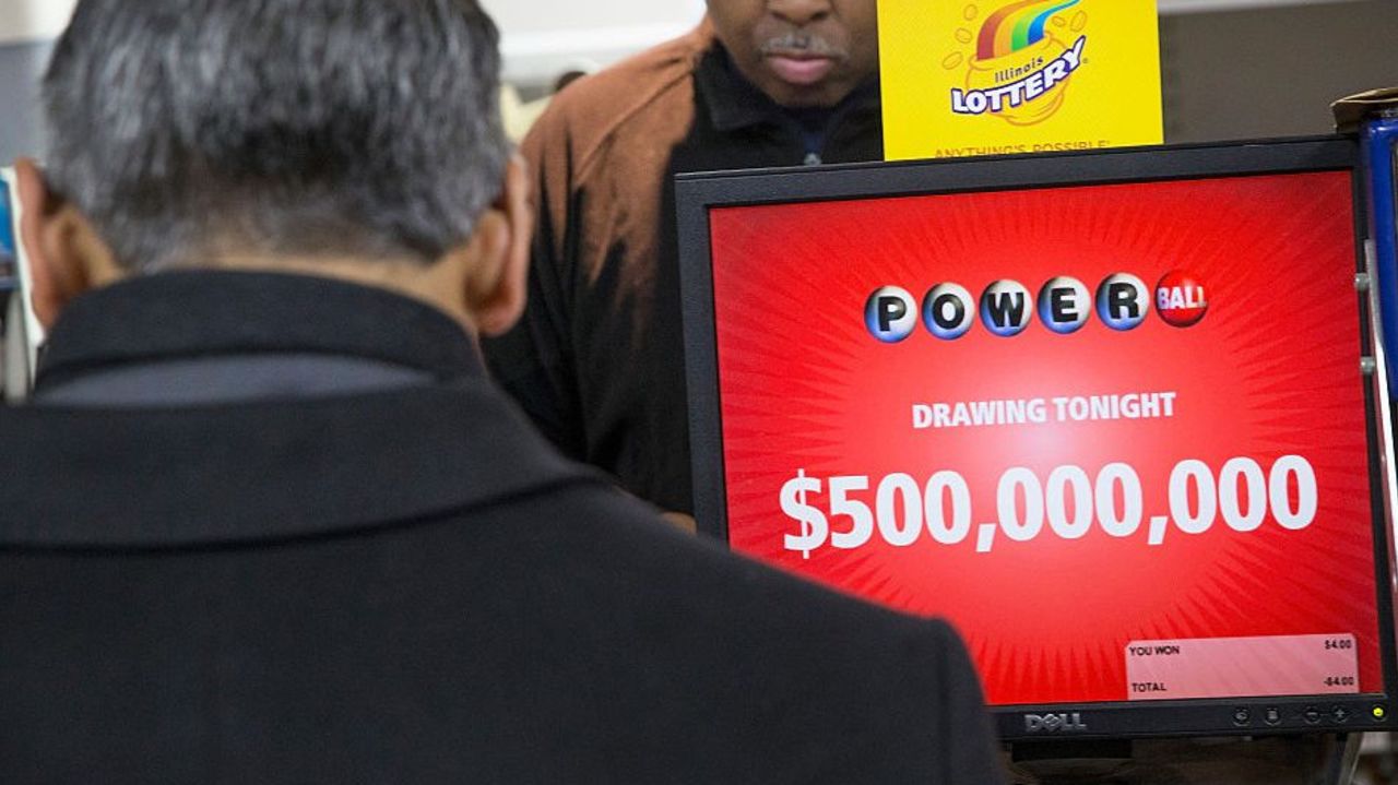 CHICAGO, IL - FEBRUARY 11:  Kirk Cook prints a Powerball lottery ticket for a customer at a 7-Eleven store on February 11, 2015 in Chicago, Illinois. Ticket sales have caused the jackpot to grow $500 million, one of the largest in the game's history.