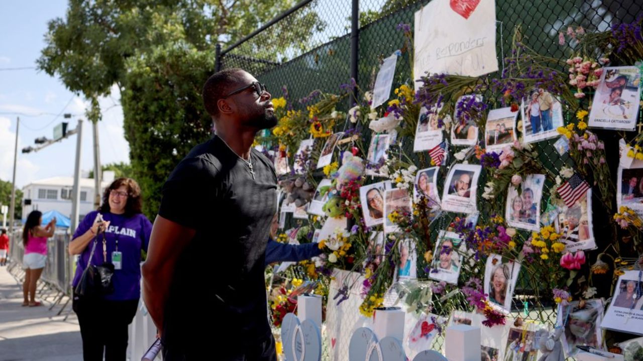 SURFSIDE, FLORIDA - JULY 08: Former NBA player Dwyane Wade of the Miami Heat pays his respects at the memorial site for victims of the collapsed 12-story Champlain Towers South condo building on July 08, 2021 in Surfside, Florida. With the death toll currently at 60 and 80 people still missing, rescue workers have shifted the operation to recovery efforts.