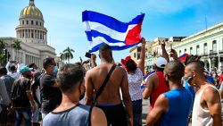 TOPSHOT - Cubans are seen outside Havana's Capitol during a demonstration against the government of Cuban President Miguel Diaz-Canel in Havana, on July 11, 2021. - Thousands of Cubans took part in rare protests Sunday against the communist government, marching through a town chanting "Down with the dictatorship" and "We want liberty." (Photo by YAMIL LAGE / AFP)