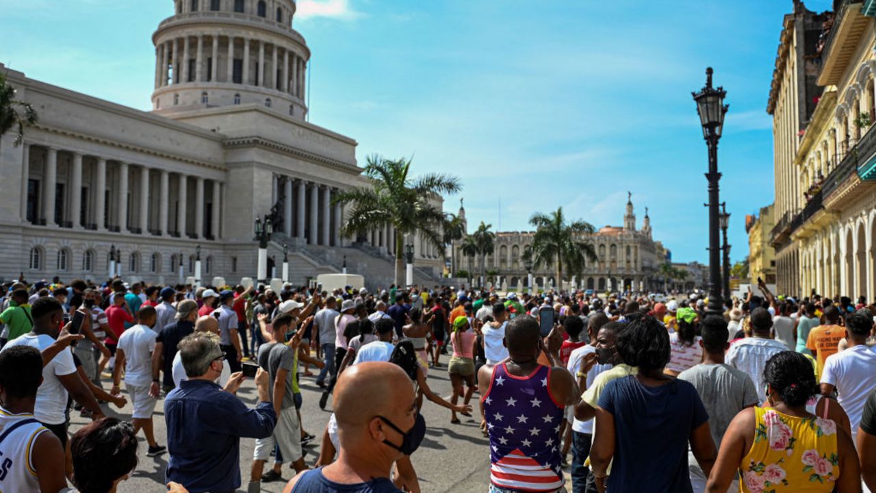 Cubans are seen outside Havana's Capitol during a demonstration against the government of Cuban President Miguel Diaz-Canel in Havana, on July 11, 2021. - Thousands of Cubans took part in rare protests Sunday against the communist government, marching through a town chanting "Down with the dictatorship" and "We want liberty." (Photo by YAMIL LAGE / AFP)