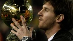 Barcelona's Argentinian forward Lionel Messi poses with his trophy of European footballer of the year award, the "Ballon d'Or" (Golden ball), before the Spanish League match Barcelona against Espanyol  at the New Camp Stadium in Barcelona, on December 12, 2009. AFP PHOTO / JOSEP LAGO