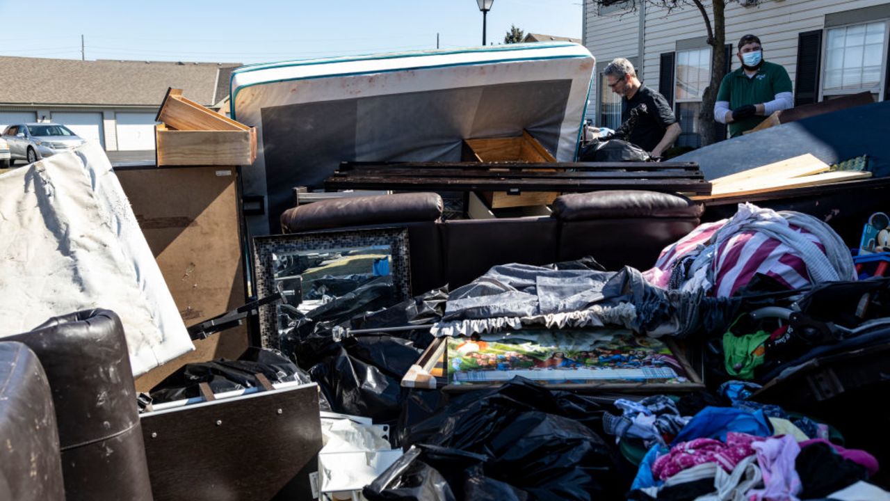 COLUMBUS, OH - MARCH 03:  Workers Doug Boylan, 65, and Keaton Hornbeck, 24, of West Jefferson, Ohio remove belongings from a residence in the unincorporated community of Galloway on March 3, 2021 west of Columbus, Ohio. Property management teams are given 1 1/2 hours to remove all items from the property under supervision of the service bailiff.