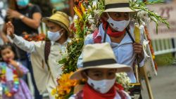 Boys carry flower arrangements known as "Silletas" at the "Silleteritos" parade during Medellin«s Flower Festival, amid the COVID 19 pandemic in Santa Elena municipality near Medellin, on August 7, 2020.  The 202q Medellin's Flower Festival takes place between the 6 and the 22dn of August. - The Medellin's Flower Festival takes place between August 6 and 22, 2021. (Photo by JOAQUIN SARMIENTO / AFP)