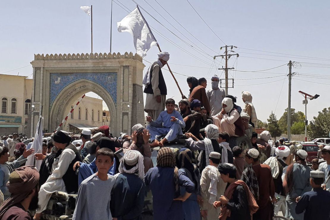 Combatientes talibanes parados en un vehículo junto a la carretera en Kandahar. (Photo by - / AFP)