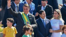 Brazilian President Jair Bolsonaro (L) and his ministers take part in the flag-raising ceremony at Alvorada Palace, during the Independence Day celebrations in Brasilia, on September 7, 2021. - Fighting record-low poll numbers, a weakening economy and a judiciary he says is stacked against him, President Jair Bolsonaro has called huge rallies for Brazilian independence day Tuesday, seeking to fire up his far-right base. (Photo by EVARISTO SA / AFP)