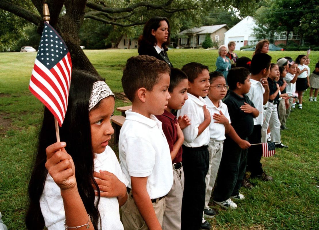 Una clase de estudiantes hispanos recita el Juramento a la Bandera durante un servicio conmemorativo del 11 de septiembre de 2003 en la Escuela Primaria Birdwell en Tyler, Texas.