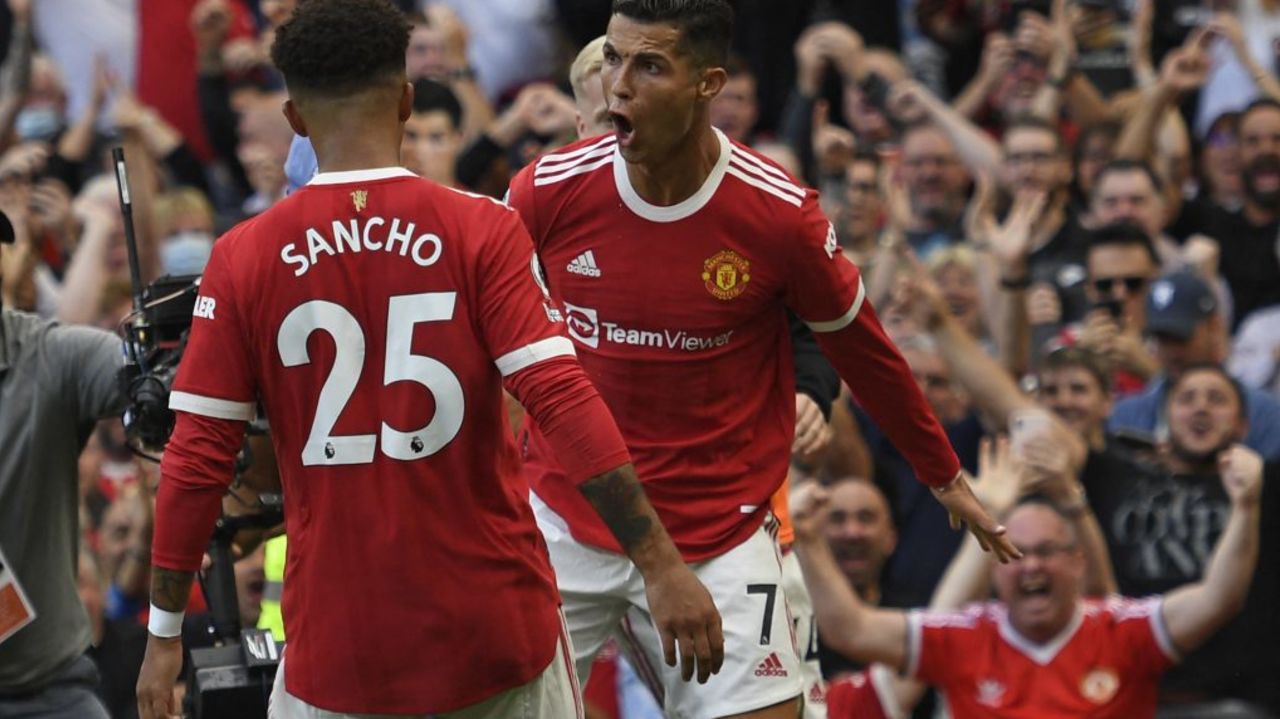 Manchester United's Portuguese striker Cristiano Ronaldo (R) celebrates with Manchester United's English striker Jadon Sancho (L) after scoring their second goal during the English Premier League football match between Manchester United and Newcastle at Old Trafford in Manchester, north west England, on September 11, 2021. - RESTRICTED TO EDITORIAL USE. No use with unauthorized audio, video, data, fixture lists, club/league logos or 'live' services. Online in-match use limited to 120 images. An additional 40 images may be used in extra time. No video emulation. Social media in-match use limited to 120 images. An additional 40 images may be used in extra time. No use in betting publications, games or single club/league/player publications. (Photo by Oli SCARFF / AFP) / RESTRICTED TO EDITORIAL USE. No use with unauthorized audio, video, data, fixture lists, club/league logos or 'live' services. Online in-match use limited to 120 images. An additional 40 images may be used in extra time. No video emulation. Social media in-match use limited to 120 images. An additional 40 images may be used in extra time. No use in betting publications, games or single club/league/player publications. / RESTRICTED TO EDITORIAL USE. No use with unauthorized audio, video, data, fixture lists, club/league logos or 'live' services. Online in-match use limited to 120 images. An additional 40 images may be used in extra time. No video emulation. Social media in-match use limited to 120 images. An additional 40 images may be used in extra time. No use in betting publications, games or single club/league/player publications.