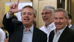 Argentina's President-elect Alberto Fernandez flashes the "Lula Free" sign next to former Paraguayan president Fernando Lugo (C) and Argentine deputy Felipe Sola, before the opening of the second meeting of Puebla Group -formed by leftist figures- in Buenos Aires, on November 9, 2019. - Brazil's leftist icon Luiz Inacio Lula da Silva walked free from jail Friday after a year and a half behind bars for corruption following a court ruling that could release thousands of convicts. (Photo by Alejandro PAGNI / AFP)