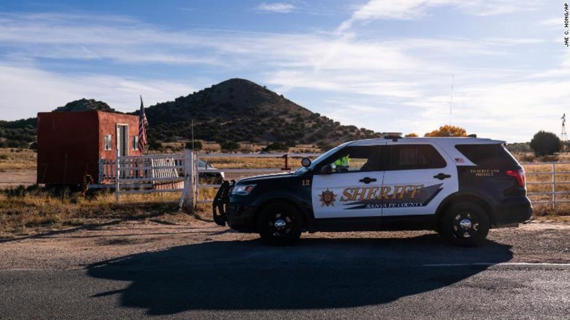 Un ayudante del sheriff del condado de Santa Fe habla con un guardia de seguridad en la entrada del Rancho Bonanza Creek en Santa Fe, Nuevo Mexico.