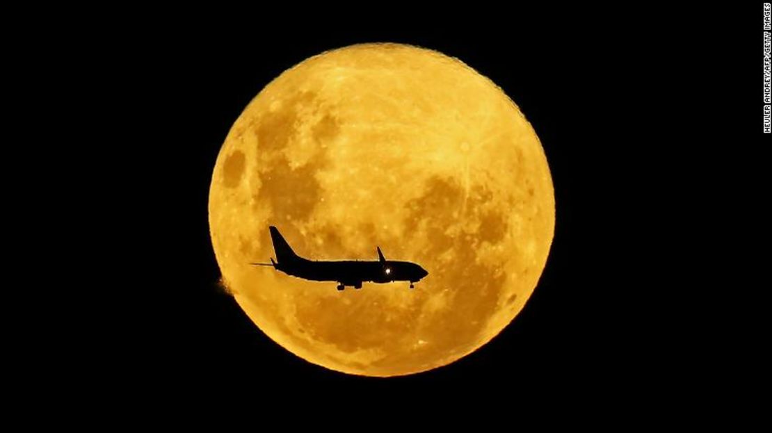 Esta imagen, tomada en Brasil, muestra a un avión pasando por delante de la superluna de marzo de 2020.