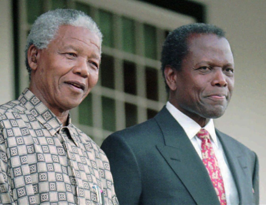 El presidente de Sudáfrica Nelson Mandela se encuentra junto a Poitier en una conferencia de prensa en Ciudad del Cabo, Sudáfrica, en 1996. Poitier interpretó a Mandela en la película "Mandela y de Klerk". Crédito: Sasa Kralj/AP