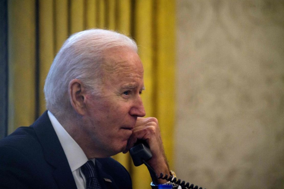 US President Joe Biden speaks on the phone to his Ukrainian counterpart Volodymyr Zelensky in the Oval Office at the White House in Washington, DC, on December 9, 2021. (Photo by Nicholas Kamm / AFP)