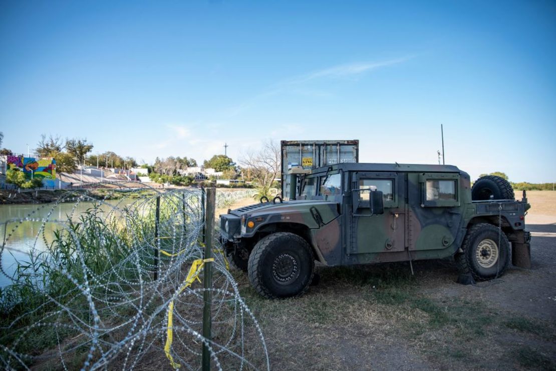 Contenedores de envío y vehículos militares de vehículos multipropósito de alta movilidad se alinean en el área cerca del río Grande el 19 de noviembre de 2021 en Eagle Pass, Texas.